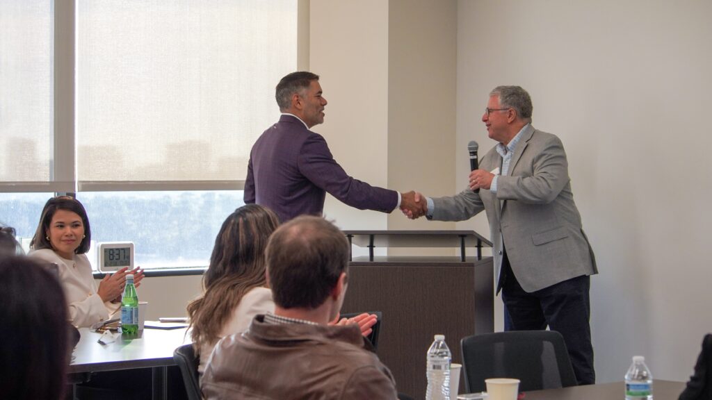 Mario Castillo, District H Council Member, shaking Steve Maislin's hand at Greater Houston Community Foundation