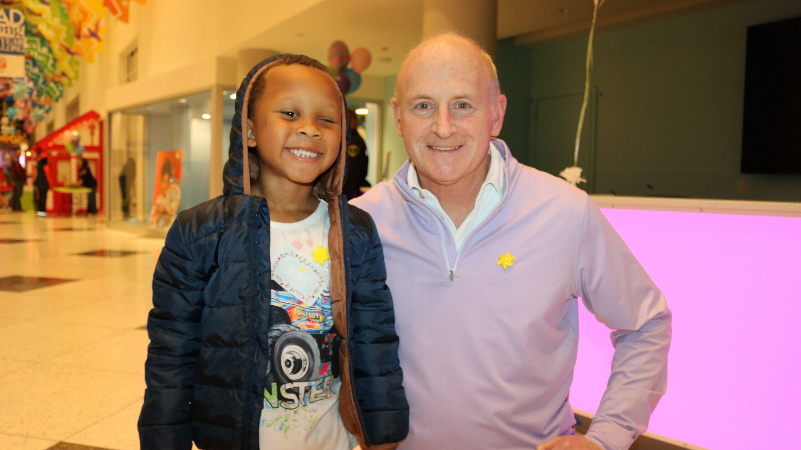 Bret Sanders, Sunshine Kids Board Chair, with Adonis at a holiday party